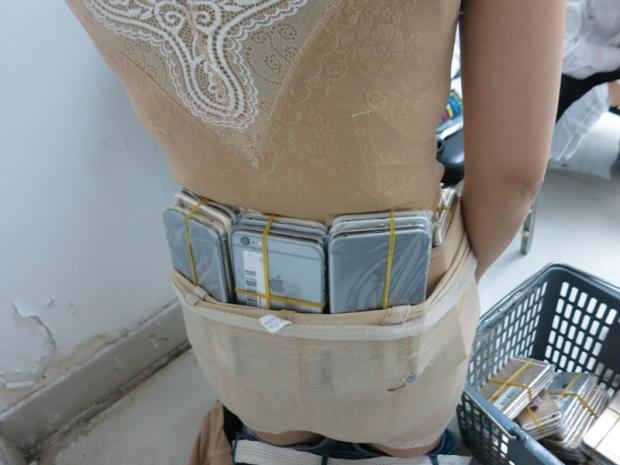 Woman caught smuggling 102 iPhones strapped to her body 03