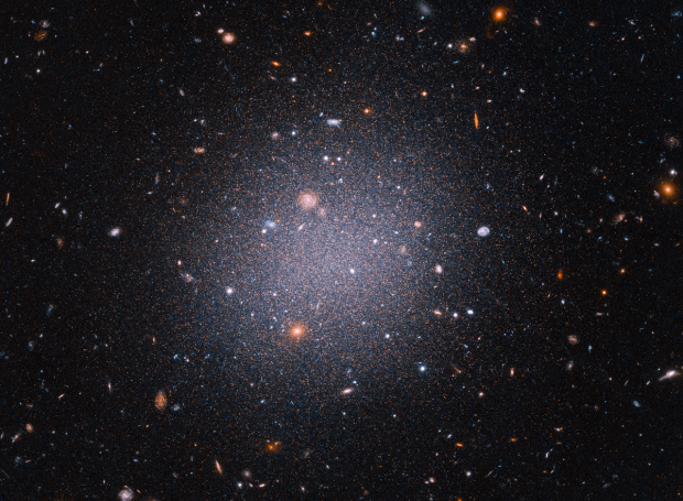 Hubble reveals odd 'see through' galaxy that lacks dark matter 'glue'