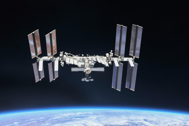 Open enlarged image NASA releases jaw-dropping ISS photo of a crescent moon above Earth