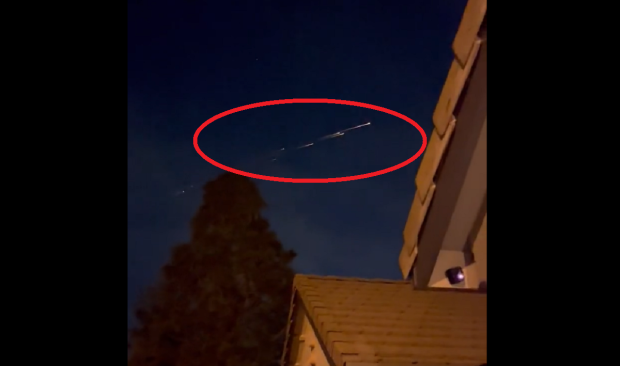 Unidentified fiery objects caught on video streaking across the night sky