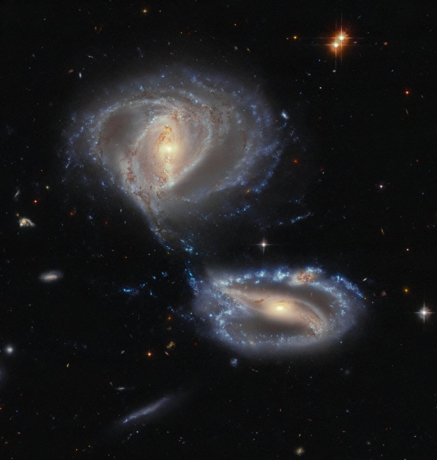 NASA telescope photographs two objects in deep space merging into one