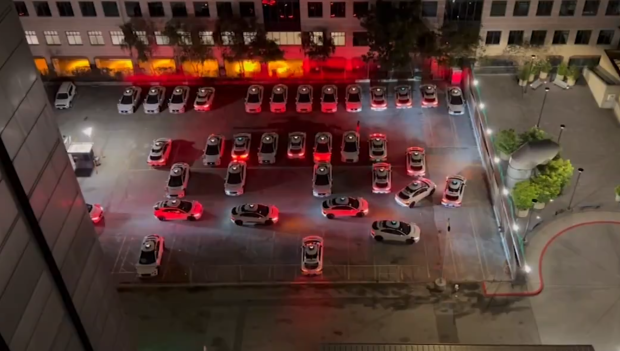 Self-driving cars are gathering at night to honk at each other